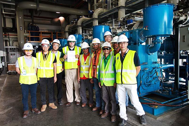 Ten 澳门足彩app team members standing inside SAFRAN Landing Systems.